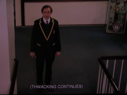 Alan Partridge stares with fear in his eyes as the THWACKING CONTINUES